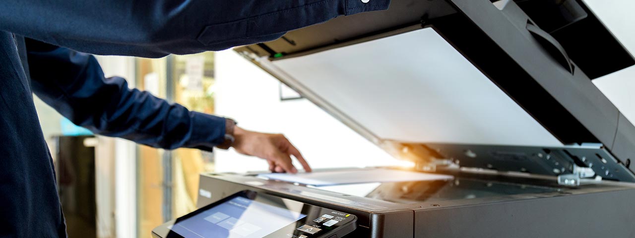 Man scanning a document on a copier Copiers